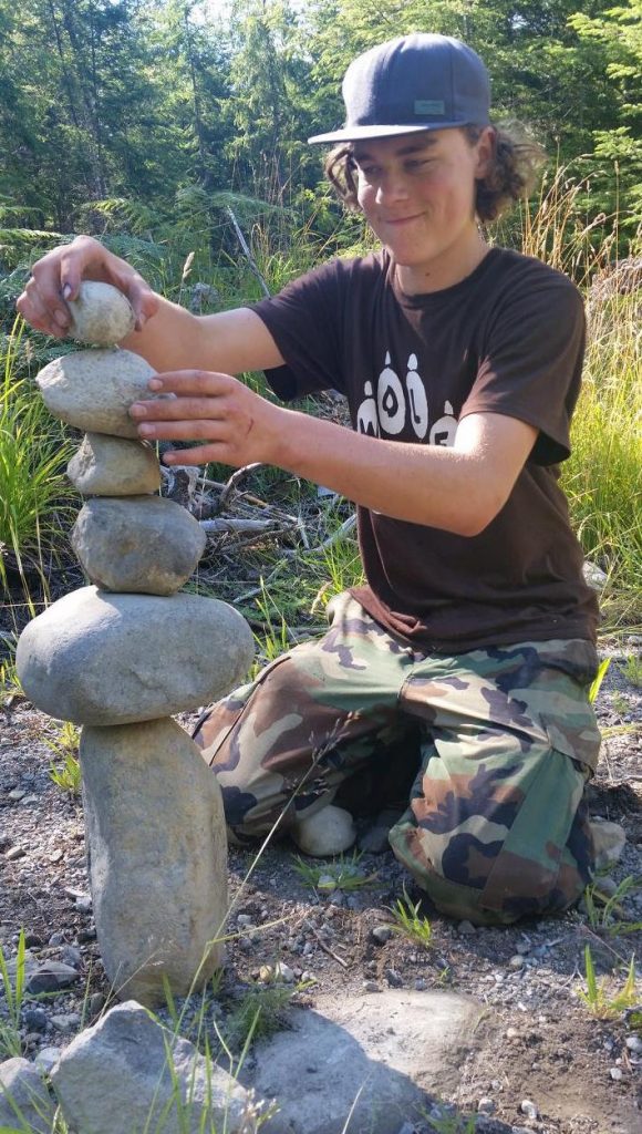 2016 Apprentice Kyler Shumaker building rock cairn at survival training.
