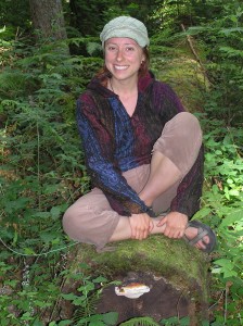 instructor-Megan-Damofle-perched-on-log-in-forest.jpg